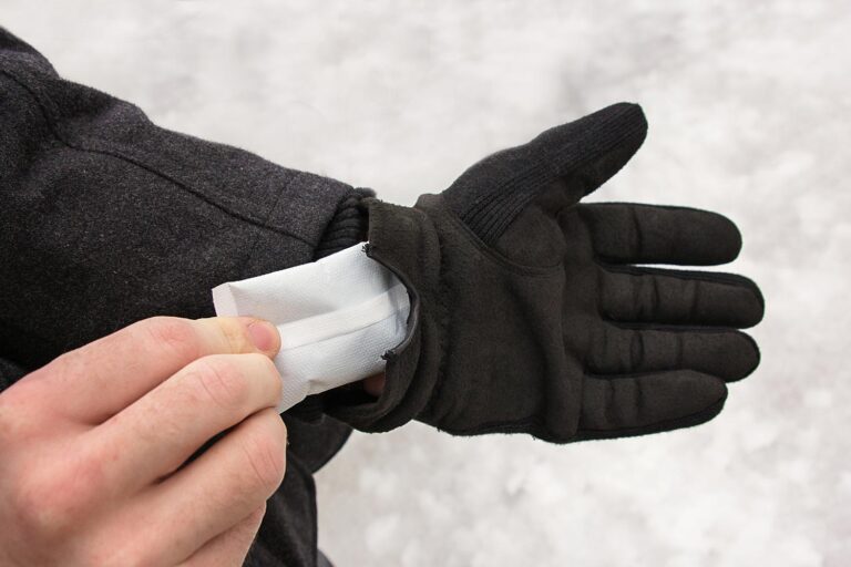 Person placing a SubZero Hand Warmer into glove