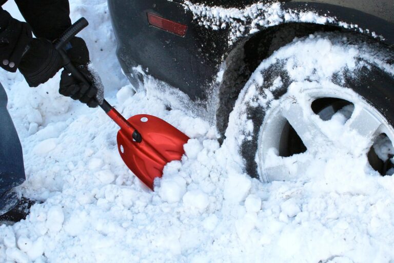 SubZero Emergency Shovel scooping snow next to vehicle